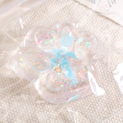 Jucarie Antistres Squishy, Flippy, cu Revenire Lenta, Squeeze Pinch Family, Model Cat Paw, 6.5 x 7 cm, din Tpr, 4-6 Ani, Model 2 Flori, Transparent
